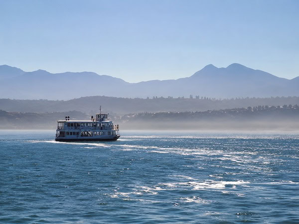 Shimmering Ferry Beneath Blue Mountains