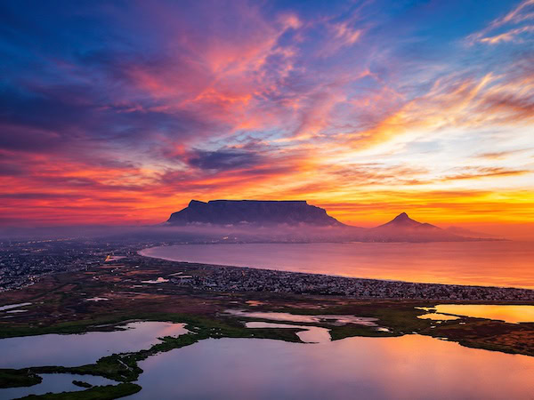 Sunset Over Coastal Wetlands and Mountains